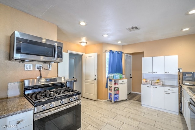 2450 Tournament St, Las Vegas, NV 89142 - kitchen featuring recessed lighting, visible vents, white cabinets, and stainless steel appliances