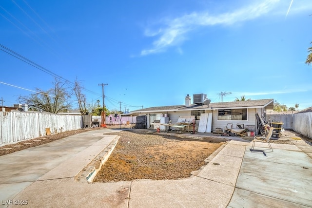 2450 Tournament St, Las Vegas, NV 89142 - view of front of property featuring a patio, central AC unit, a fenced backyard, and driveway