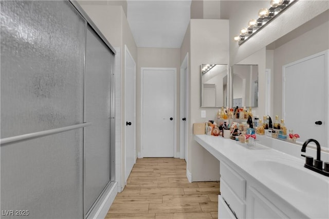 5988 Turtle River Ave, Las Vegas, NV 89156 - bathroom with a stall shower, wood finished floors, and vanity