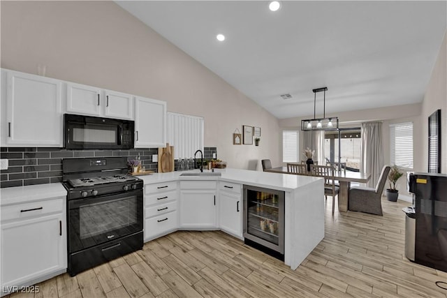 5988 Turtle River Ave, Las Vegas, NV 89156 - kitchen featuring light countertops, a peninsula, a sink, and black appliances
