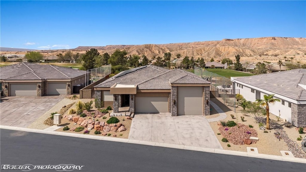 view of front facade featuring stone siding, stucco siding, concrete driveway, and a garage