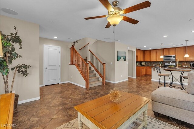 2376 Via Firenze, Henderson, NV 89044 - tiled living room with stairs, baseboards, a ceiling fan, and recessed lighting