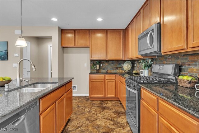 2376 Via Firenze, Henderson, NV 89044 - kitchen with appliances with stainless steel finishes, a sink, backsplash, dark stone counters, and brown cabinetry