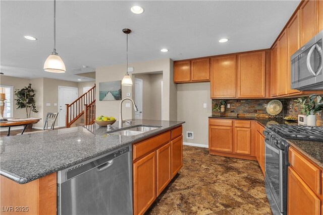2376 Via Firenze, Henderson, NV 89044 - kitchen featuring appliances with stainless steel finishes, a sink, decorative backsplash, dark stone countertops, and pendant lighting