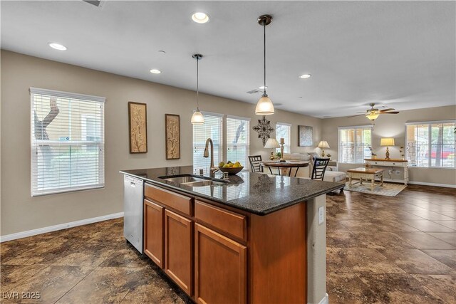 2376 Via Firenze, Henderson, NV 89044 - kitchen featuring a sink, stainless steel dishwasher, baseboards, brown cabinetry, and a kitchen island with sink