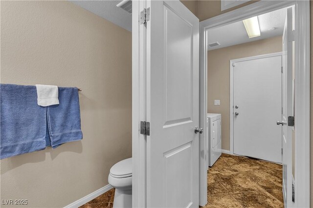 2376 Via Firenze, Henderson, NV 89044 - bathroom with independent washer and dryer, baseboards, and toilet