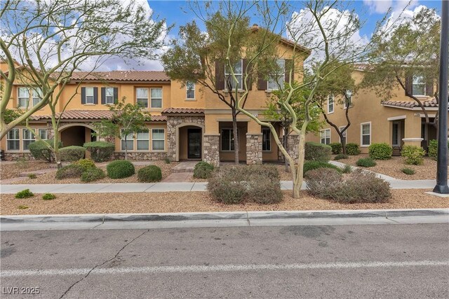 2376 Via Firenze, Henderson, NV 89044 - view of property featuring stucco siding, stone siding, and a tile roof