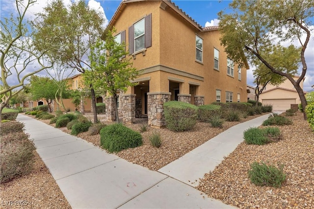 2376 Via Firenze, Henderson, NV 89044 - view of side of property with stucco siding, stone siding, and a detached garage