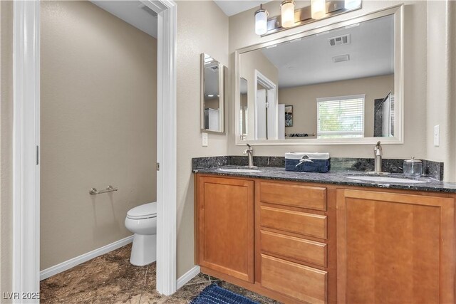 2376 Via Firenze, Henderson, NV 89044 - full bathroom with double vanity, toilet, and baseboards