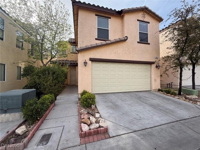 5661 Bonds Flat St, Las Vegas, NV 89148 - view of front of house with a tile roof, stucco siding, a garage, and concrete driveway