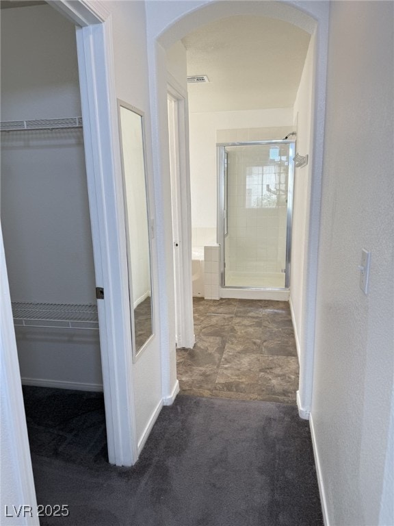 5661 Bonds Flat St, Las Vegas, NV 89148 - hallway featuring arched walkways, baseboards, and carpet floors