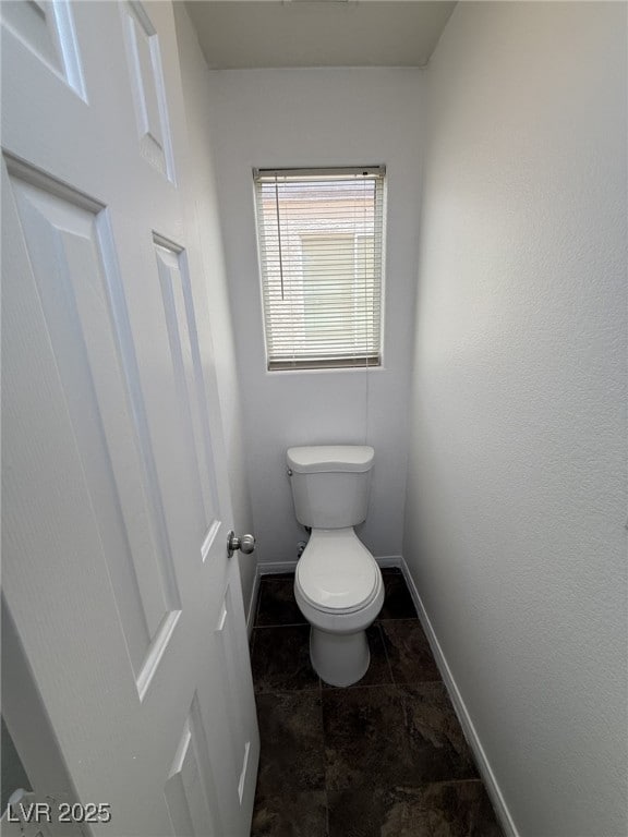 5661 Bonds Flat St, Las Vegas, NV 89148 - bathroom with toilet, baseboards, and tile patterned flooring