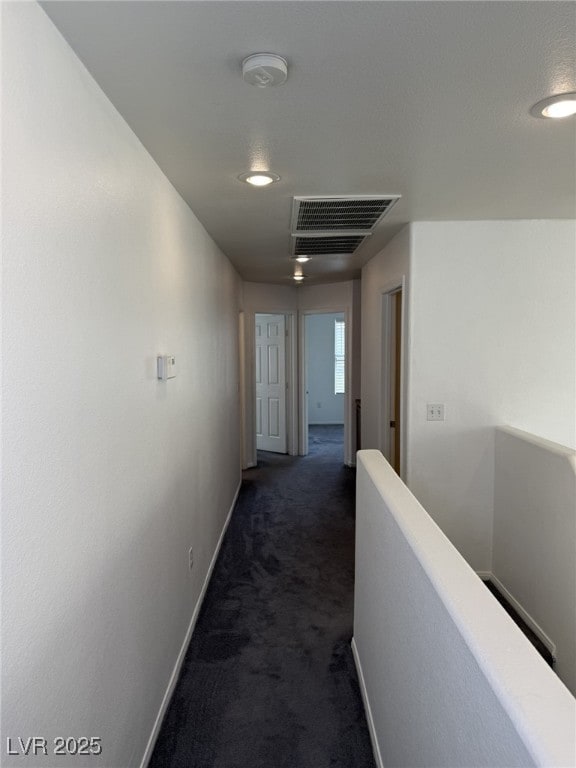 5661 Bonds Flat St, Las Vegas, NV 89148 - corridor with an upstairs landing, dark colored carpet, baseboards, and recessed lighting