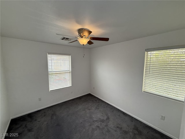 5661 Bonds Flat St, Las Vegas, NV 89148 - spare room with ceiling fan, plenty of natural light, dark colored carpet, and baseboards