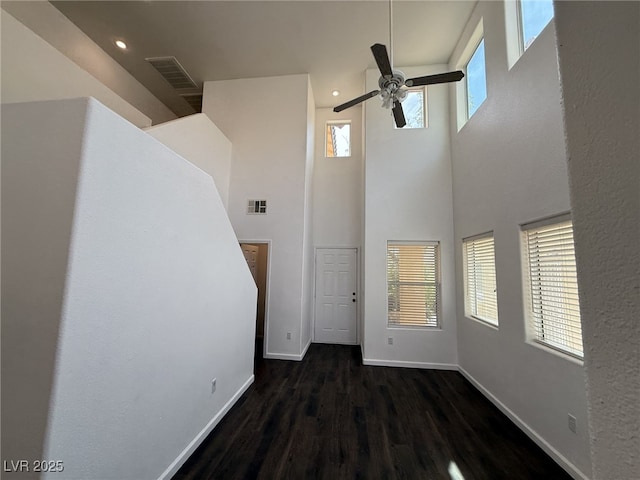 5661 Bonds Flat St, Las Vegas, NV 89148 - entryway with ceiling fan, a towering ceiling, baseboards, healthy amount of natural light, and dark wood finished floors