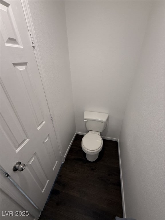 5661 Bonds Flat St, Las Vegas, NV 89148 - bathroom with wood finished floors, baseboards, and toilet