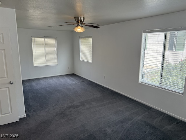 5661 Bonds Flat St, Las Vegas, NV 89148 - spare room with dark colored carpet, a ceiling fan, plenty of natural light, and baseboards