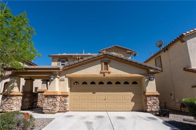 6036 Sierra Lakes St, North Las Vegas, NV 89031 - mediterranean / spanish home with an attached garage, stone siding, driveway, and stucco siding