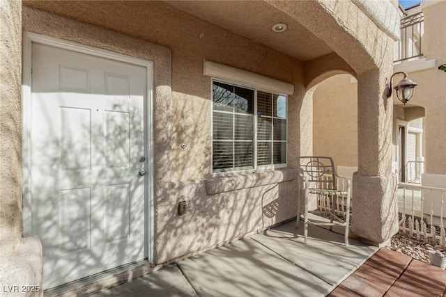 entrance to property featuring stucco siding