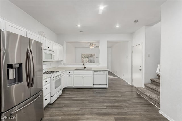 kitchen with light countertops, white cabinets, white appliances, a ceiling fan, and a sink