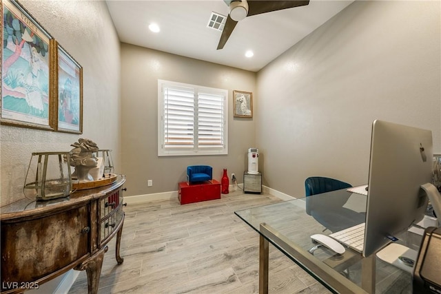 office area with visible vents, ceiling fan, wood finished floors, and baseboards