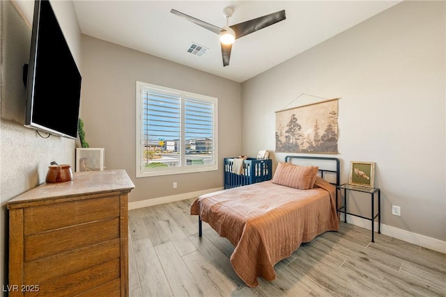 bedroom featuring visible vents, baseboards, ceiling fan, and light wood-style floors