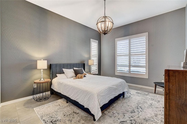 bedroom with tile patterned flooring, baseboards, and a chandelier