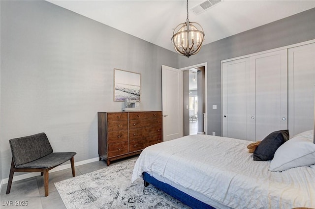tiled bedroom with a closet, baseboards, visible vents, and a notable chandelier