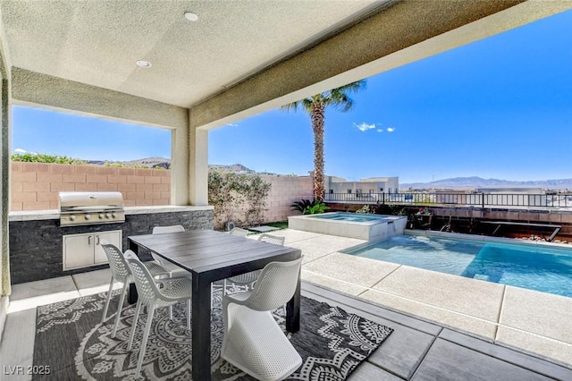 view of patio / terrace featuring a fenced backyard, outdoor dining area, area for grilling, and a mountain view