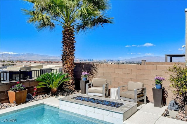 view of pool with a fire pit and fence