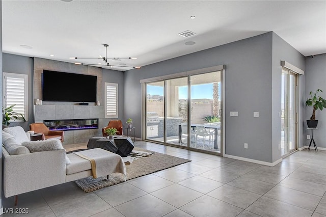 living area featuring a tiled fireplace, tile patterned floors, baseboards, and visible vents