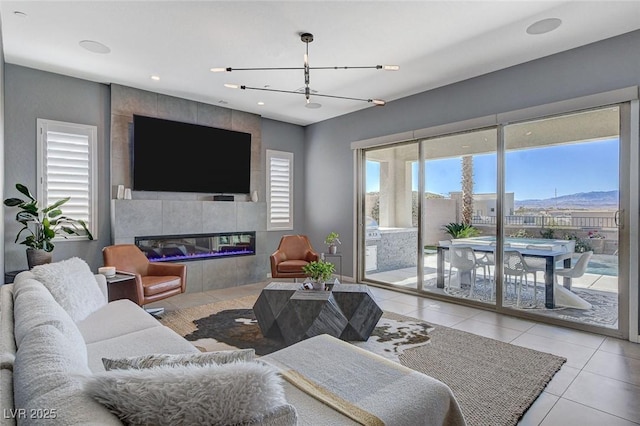 tiled living room featuring a fireplace and plenty of natural light