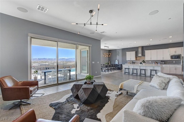 living room with recessed lighting, light tile patterned flooring, baseboards, and visible vents