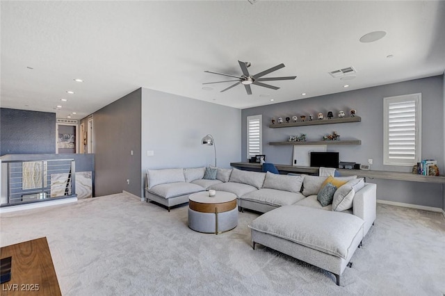 carpeted living area featuring baseboards, ceiling fan, visible vents, and recessed lighting