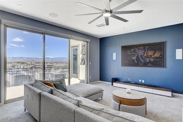 carpeted living area with baseboards, baseboard heating, ceiling fan, and a textured wall
