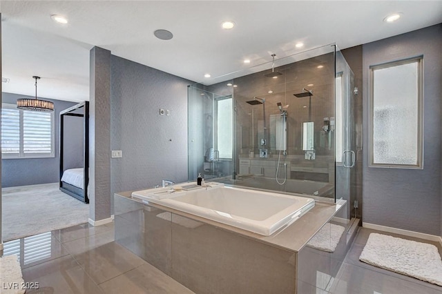 ensuite bathroom with a garden tub, baseboards, a stall shower, and tile patterned flooring