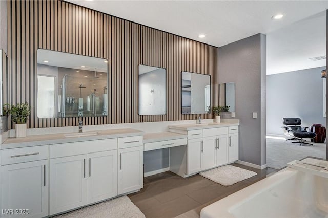 full bathroom featuring visible vents, wallpapered walls, a stall shower, and vanity