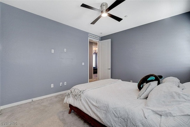 carpeted bedroom featuring baseboards and ceiling fan