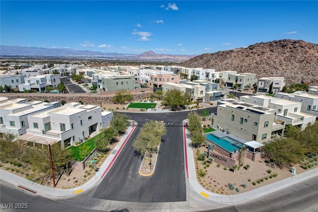 drone / aerial view featuring a residential view and a mountain view