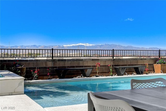 pool with a mountain view and fence