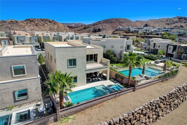 pool with a patio, a mountain view, and a fenced backyard