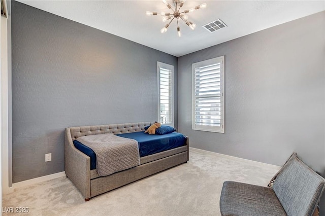 carpeted bedroom featuring baseboards, a notable chandelier, and visible vents