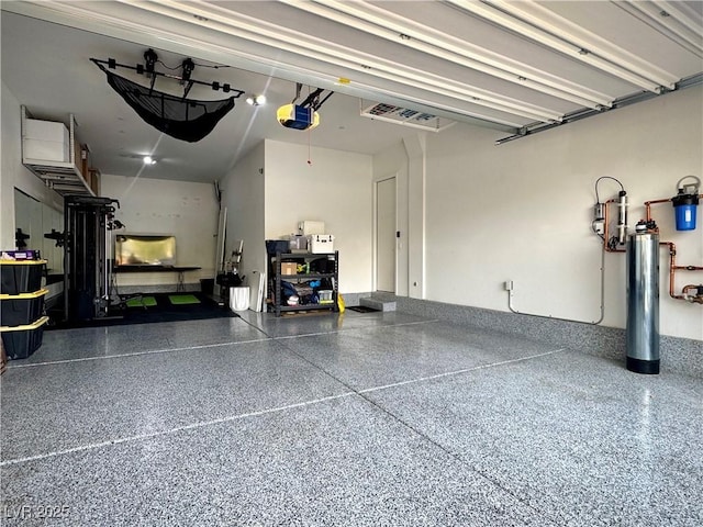 garage featuring a garage door opener and visible vents