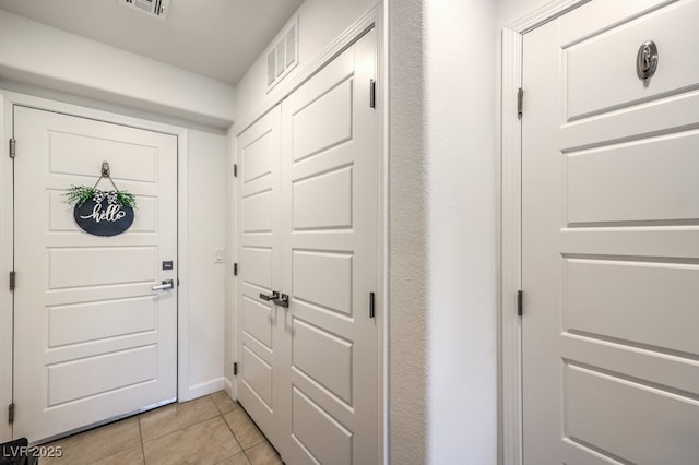 entryway featuring light tile patterned floors and visible vents