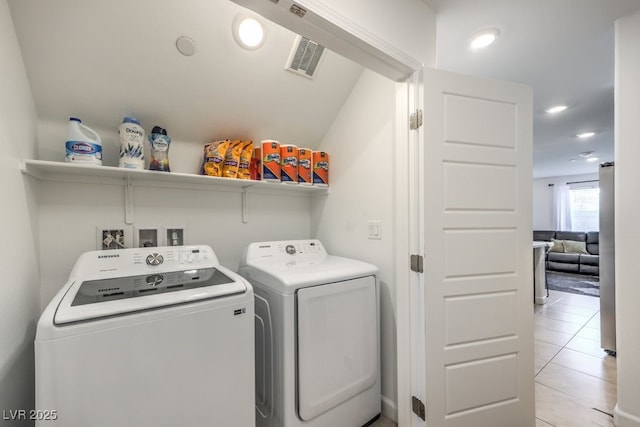 clothes washing area with visible vents, recessed lighting, light tile patterned floors, laundry area, and washing machine and clothes dryer