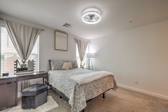 bedroom featuring visible vents, light colored carpet, and baseboards