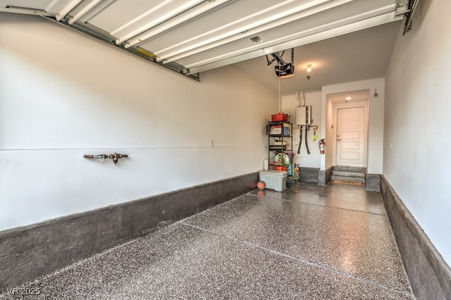 garage featuring water heater and a garage door opener