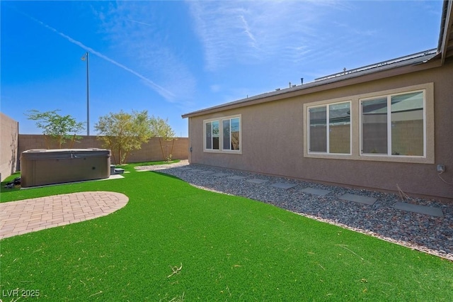 view of yard with a hot tub, a patio, and a fenced backyard
