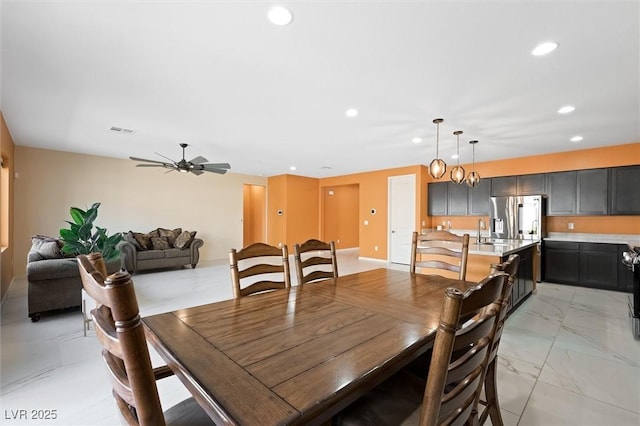dining area featuring recessed lighting, ceiling fan, visible vents, and marble finish floor