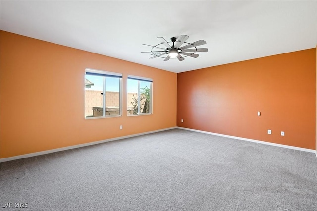 unfurnished room featuring baseboards, a ceiling fan, and carpet